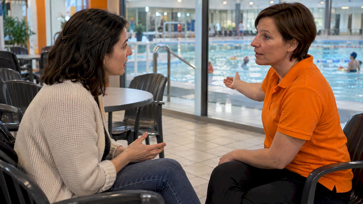 Die Mutter stellt der Schwimmkursleitung eine Frage